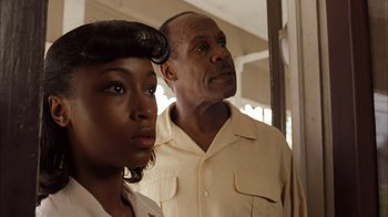 Movie still from “Honeydripper” (2007), directed by John Sayles – A man and a woman standing next to each other in front of a mirror; Close Up shot, Over the shoulder angle