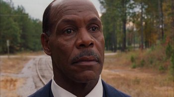 Movie still from “Honeydripper” (2007), directed by John Sayles – A man in a suit and tie looking into the distance; Close Up shot, Low angle