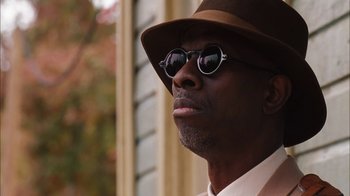Movie still from “Honeydripper” (2007), directed by John Sayles – A person wearing sunglasses and a hat; Close Up shot, Low angle