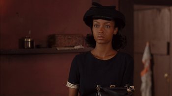 Movie still from “Honeydripper” (2007), directed by John Sayles – A woman in a black dress and a black hat; Close Up shot, Over the shoulder angle