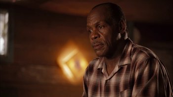 Movie still from “Honeydripper” (2007), directed by John Sayles – An older black man in a plaid shirt looking to his left; Close Up shot, Over the shoulder angle