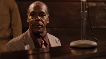 Movie still from “Honeydripper” (2007), directed by John Sayles – An older man sitting at a piano in front of a microphone; Close Up shot, Low angle