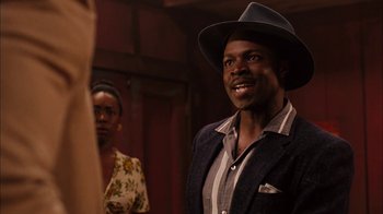 Movie still from “Honeydripper” (2007), directed by John Sayles – A man wearing a hat standing next to a woman; Close Up shot, Over the shoulder angle