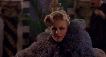 Movie still from “Hoodlum” (1997), directed by Bill Duke – A person wearing a fur coat; Close Up shot, Over the shoulder angle