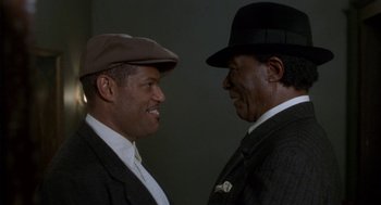 Movie still from “Hoodlum” (1997), directed by Bill Duke – A couple of men standing next to each other; Close Up shot, Low angle