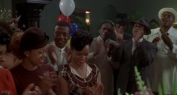 Movie still from “Hoodlum” (1997), directed by Bill Duke – A group of men and women standing in a room; Medium shot, High angle