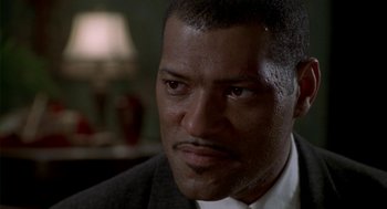 Movie still from “Hoodlum” (1997), directed by Bill Duke – A man that is looking at the camera; Close Up shot, Low angle