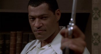 Movie still from “Hoodlum” (1997), directed by Bill Duke – A person holding a gun; Close Up shot, Low angle