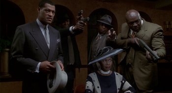 Movie still from “Hoodlum” (1997), directed by Bill Duke – A group of men and a woman in suits and hats; Medium shot, High angle