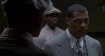 Movie still from “Hoodlum” (1997), directed by Bill Duke – A group of men standing next to each other in a room; Close Up shot, Over the shoulder angle