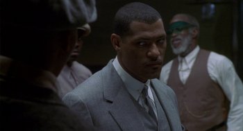 Movie still from “Hoodlum” (1997), directed by Bill Duke – A man in a gray suit and a tie; Close Up shot, Over the shoulder angle