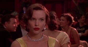 Movie still from “Hoodlum” (1997), directed by Bill Duke – A person wearing a necklace; Close Up shot, Over the shoulder angle