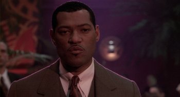 Movie still from “Hoodlum” (1997), directed by Bill Duke – A person wearing a suit and tie; Close Up shot, Low angle