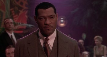 Movie still from “Hoodlum” (1997), directed by Bill Duke – A man in a suit and a tie; Close Up shot, Over the shoulder angle