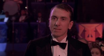 Movie still from “Hoodlum” (1997), directed by Bill Duke – A person wearing a suit and a bow tie; Close Up shot, Over the shoulder angle