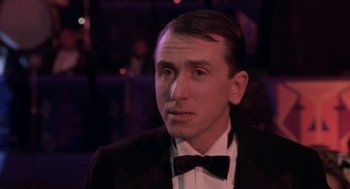 Movie still from “Hoodlum” (1997), directed by Bill Duke – A person wearing a suit and a bow tie; Close Up shot, Over the shoulder angle