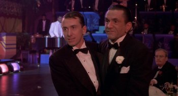 Movie still from “Hoodlum” (1997), directed by Bill Duke – Two men in tuxedos pose for a picture; Medium shot, Low angle