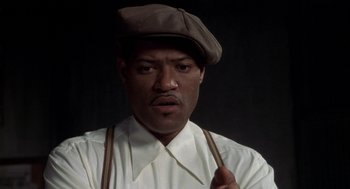 Movie still from “Hoodlum” (1997), directed by Bill Duke – A man wearing a brown hat and suspenders; Close Up shot, Low angle