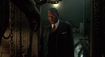 Movie still from “Hoodlum” (1997), directed by Bill Duke – A man in a suit and tie; Medium shot, Low angle