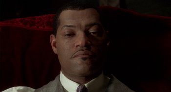 Movie still from “Hoodlum” (1997), directed by Bill Duke – A person wearing a suit and tie; Close Up shot, Low angle