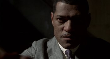Movie still from “Hoodlum” (1997), directed by Bill Duke – A person wearing a suit and tie; Close Up shot, Low angle