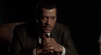 Movie still from “Hoodlum” (1997), directed by Bill Duke – A man that is wearing a suit and tie; Close Up shot, Low angle