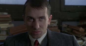 Movie still from “Hoodlum” (1997), directed by Bill Duke – A person wearing a suit and tie; Close Up shot, Low angle