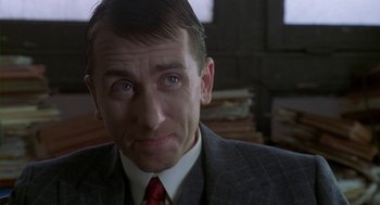 Movie still from “Hoodlum” (1997), directed by Bill Duke – A person wearing a suit and tie; Close Up shot, Over the shoulder angle