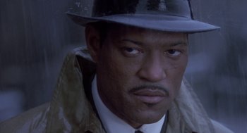 Movie still from “Hoodlum” (1997), directed by Bill Duke – A person wearing a hat and a jacket; Close Up shot, High angle