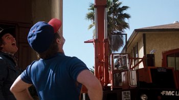 Movie still from “Hooper” (1978), directed by Hal Needham – A man standing on the back of a red truck; Medium shot, Low angle