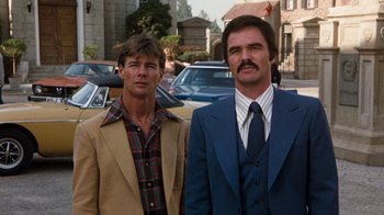 Movie still from “Hooper” (1978), directed by Hal Needham – Two men standing next to each other on the street; Medium shot, Low angle