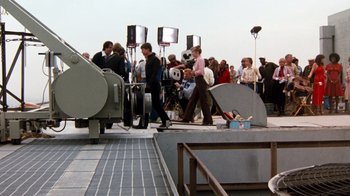 Movie still from “Hooper” (1978), directed by Hal Needham – A group of people standing next to each other on a sidewalk; Wide shot, High angle