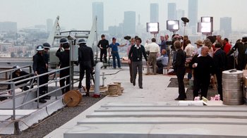 Movie still from “Hooper” (1978), directed by Hal Needham – A group of people standing on top of a building; Wide shot, Over the shoulder angle