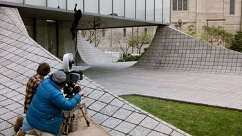 Movie still from “Hooper” (1978), directed by Hal Needham – A man is filming a skate park with a video camera; Extreme Wide shot, High angle