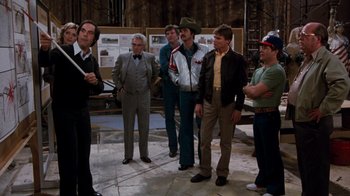 Movie still from “Hooper” (1978), directed by Hal Needham – A group of men standing next to each other on the ground; Wide shot, High angle