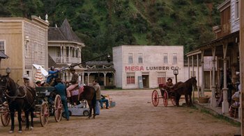 Movie still from “Hooper” (1978), directed by Hal Needham – A group of people standing next to a horse drawn carriage; Extreme Wide shot, Over the shoulder angle
