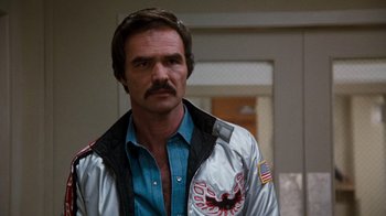 Movie still from “Hooper” (1978), directed by Hal Needham – A person wearing a jacket; Close Up shot, Over the shoulder angle