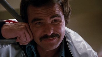 Movie still from “Hooper” (1978), directed by Hal Needham – A person with a mustache; Close Up shot, Low angle