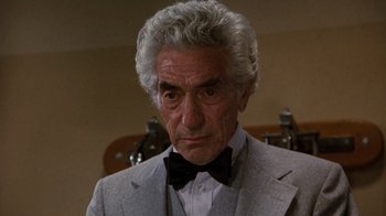 Movie still from “Hooper” (1978), directed by Hal Needham – An older man in a suit and bow tie; Close Up shot, Low angle