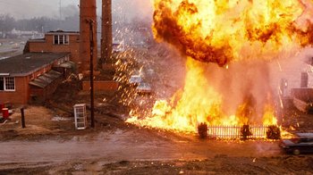 Movie still from “Hooper” (1978), directed by Hal Needham – An explosion is seen in the background of this picture; Extreme Wide shot, High angle