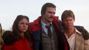 Movie still from “Hooper” (1978), directed by Hal Needham – A group of people standing next to each other; Medium shot, Low angle