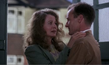Movie still from “Hope and Glory” (1987), directed by John Boorman – An older woman and a younger man are looking at one another; Close Up shot, Low angle