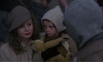 Movie still from “Hope and Glory” (1987), directed by John Boorman – A woman and a child are holding a teddy bear; Close Up shot, Over the shoulder angle