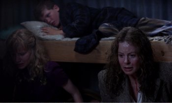 Movie still from “Hope and Glory” (1987), directed by John Boorman – A woman and two children sitting on a bunk bed; Medium shot, High angle
