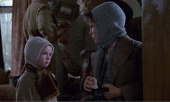 Movie still from “Hope and Glory” (1987), directed by John Boorman – Two children dressed in medieval clothing talking to each other; Close Up shot, Over the shoulder angle