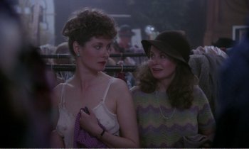 Movie still from “Hope and Glory” (1987), directed by John Boorman – Two women standing next to each other in a crowd; Medium shot, Over the shoulder angle