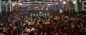 Movie still from “Hopscotch” (1980), directed by Ronald Neame – A large crowd of people sitting at tables in a restaurant; Extreme Wide shot, High angle