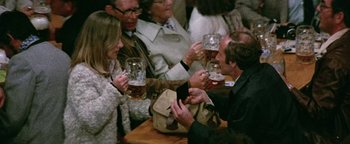 Movie still from “Hopscotch” (1980), directed by Ronald Neame – A group of people are drinking beer at a party; Medium shot, High angle