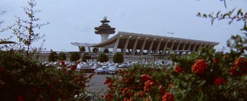 Movie still from “Hopscotch” (1980), directed by Ronald Neame – A view of an air port from a parking lot; Extreme Wide shot, Low angle