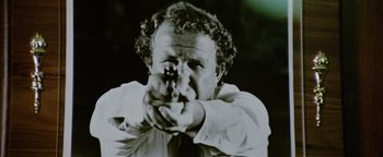Movie still from “Hopscotch” (1980), directed by Ronald Neame – A black and white photo of a man pointing a gun; Close Up shot, Low angle